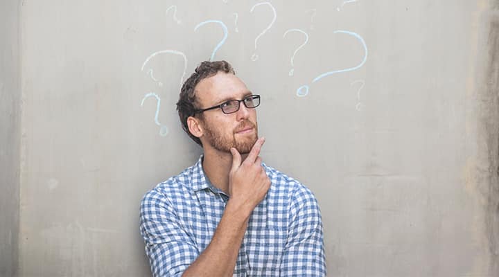 Man with chalk question marks around head thinking about magnesium